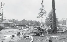  ?? ALICIA JOSSEY ?? Debris covers a street Saturday in East Brewton, Alabama. Authoritie­s suspect a tornado spurred by Tropical Storm Claudette was to blame for the damage.