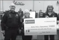 ??  ?? STATE FARM AGENT CATHY NUETZI (CENTER) PRESENTS A $10,000 grant to Yuma Police Chief John Lekan (left) and Sgt. Lori Franklin at a Feb. 21 city council meeting.