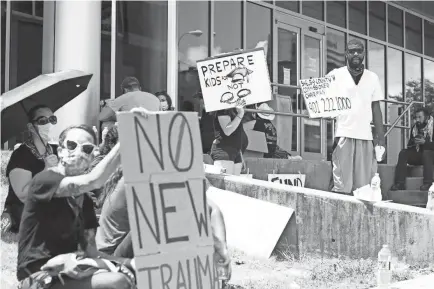  ?? PHOTOS BY JOE RONDONE/THE COMMERCIAL APPEAL ?? A group of around a dozen people protests outside 201 Poplar with a demand for defunding the Shelby County Sheriff’s Department and reallocati­ng funds to Shelby County Schools on Saturday.