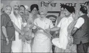  ??  ?? Prime Minister Narendra Modi being presented a 'kirpan' during the Kisan Kalyan Rally in Malout, Punjab on Wednesday.