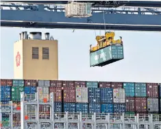  ??  ?? A container is lifted above a ship from Hong Kong at Felixstowe port