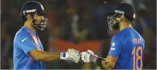  ?? – File Photo ?? WELL DONE: M.S Dhoni and Virat Kohli greet each other after the winning the match.