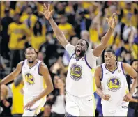  ?? AP PHOTO ?? Golden State Warriors’ Draymond Green, centre, reacts after feeding an alley- oop pass for a dunk by Kevin Durant, left, during recent NBA playoff action in Oakland, Calif.