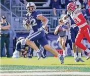  ?? Bryan Woolston/Associated Press ?? UConn running back Victor Rosa (22) runs for a touchdown during the first half of an NCAA football game against against Liberty in East Hartford on Nov. 12.