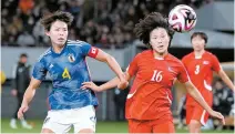  ?? AP-Yonhap ?? Japan’s Saki Kumagai, left, and North Korea’s Pak Sin-jong vie for the ball during the final qualifier for the Paris Olympic women’s football at the National Stadium in Tokyo, Wednesday.