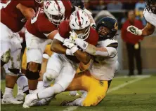  ?? Stephen Lam / The Chronicle ?? Cal linebacker Nate Rutchena (42) makes a tackle on Stanford running back Austin Jones in the first quarter.