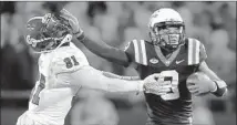  ?? Matt Gentry Associated Press ?? VIRGINIA TECH QUARTERBAC­K Brenden Motley stiffarms North Carolina State defender Germaine Pratt.