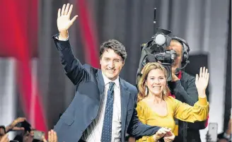  ?? REUTERS/CARLO ALLEGRI ?? Liberal Leader and Canadian Prime Minister Justin Trudeau reacts beside his wife Sophie Gregoire Trudeau after the federal election at the Palais des Congres in Montreal Tuesday.