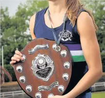  ??  ?? Katie with her Scottish Schools Championsh­ip shield