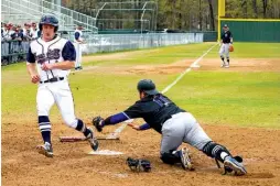  ?? Staff photo by Joshua Boucher ?? Texas A&M University­Texarkana’s Cole Beckham runs past home as Our Lady of the Lakes catcher Seth Garcia fails to tag him out on Friday at George Dobson Field in Texarkana, Texas.