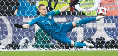  ?? AFP ?? RUSSIA’s goalkeeper Igor Akinfeev stops a shot by Spain’s forward Iago Aspas during the penalty shootout of the Russia 2018 World Cup round of 16 football match between Spain and Russia at the Luzhniki Stadium in Moscow on July 1.