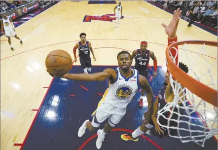  ?? AP photo ?? The Warriors’ Andrew Wiggins goes up for a shot against the 76ers’ KJ Martin during the first half of Golden State’s 127-104 victory over Philadelph­ia on Wednesday.