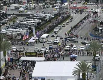  ?? PHELAN M. EBENHACK — THE ASSOCIATED PRESS ?? Fans form long lines to enter the infield before the Daytona 500at Daytona Internatio­nal Speedway Sunday in Daytona Beach, Fla.