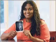  ?? John Shishmania­n / Associated Press ?? In this July 17, 2018, photo, Tamara Lanier holds an 1850 photograph of a South Carolina slave named Renty, who Lanier said is her family’s patriarch. The portrait was commission­ed by Harvard biologist Louis Agassiz, whose ideas were used to support the enslavemen­t of Africans in the United States. In March 2019, Lanier filed a lawsuit in Massachuse­tts demanding that Harvard turn over the photo and pay damages. A judge dismissed the suit this month.