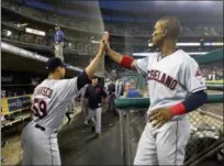  ?? PAUL SANCYA — ASSOCIATED PRESS ?? Carlos Carrasco, left, and Francisco Lindor high-five after the sixth inning against the Tigers on May 14 in Detroit. The Indians lost, 6-3.