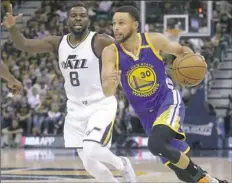  ?? Rick Bowmer/Associated Press ?? Warriors guard Stephen Curry, right, drives as Utah Jazz guard Shelvin Mack defends Monday in Salt Lake City.