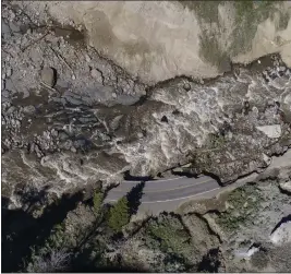  ?? DAVID GOLDMAN — THE ASSOCIATED PRESS FILE ?? Receding floodwater­s flow past sections of North Entrance Road washed away at Yellowston­e National Park in Gardiner, Mont.