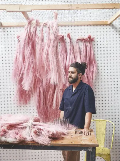  ??  ?? ABOVE Fernando in his studio, with cochineal-dyed bunches of sisal drying above him LEFT AND FAR LEFT
Fernando’s lamps are made of undyed sisal or he uses dyed fibres to create more colourful designs