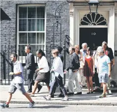  ??  ?? Victims of the Grenfell apartment tower block fire and volunteers leave 10 Downing Street after a meeting with May. — Reuters photo