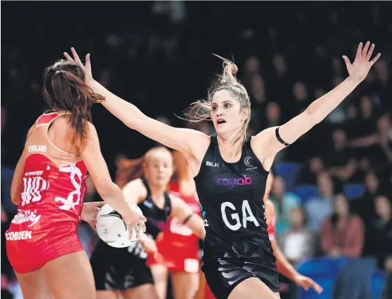  ?? Picture / Photosport ?? New Zealand goal attack Te Paea Selby-Rickit looks to block a pass from England’s Beth Cobden.