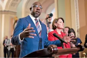  ?? AP PHOTO/J. SCOTT APPLEWHITE ?? On June 22, Sen. Raphael Warnock, D-Ga., joined at right by Sen. Amy Klobuchar, D-Minn., speaks with reporters before a key test vote on the For the People Act at the Capitol in Washington.