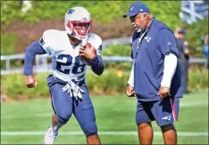  ?? BOSTON HERALD ?? STEP LIVELY: James White goes through a drill with running backs coach Ivan Fears watching yesterday at Pats training camp in Foxboro.
