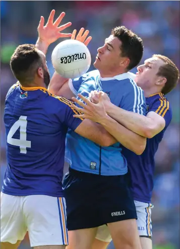  ??  ?? Paddy Andrews of Dublin in action against Diarmuid Masterson, left, and Patrick Fox of Longford during the Leinster Senior football championsh­ip semi-final in Croke Park.