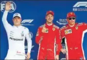  ?? REUTERS ?? Sebastian Vettel (centre) after qualifying in pole position as Valtteri Bottas (left) and Kimi Raikkonen look on.