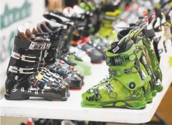  ??  ?? Tables of ski boots await the Colorado Ski and Golf’s annual Ski Rex sale in August 2016.