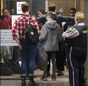  ?? CP PHOTO ?? Visitors pass through security as they attend Federal Court for a hearing to determine whether deportatio­n proceeding­s should be halted for Abdoul Abdi, the former child refugee, in Halifax on Thursday.