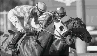  ?? BENOIT & ASSOCIATES ?? Pubilius Syrus (7), under Kent Desormeaux, beats Inscom to win the Eddie Logan Stakes at Santa Anita Park on Dec. 29.