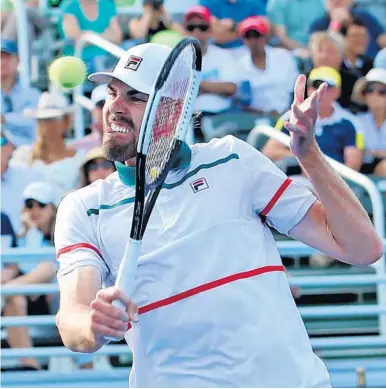  ?? JOHN MCCALL/SUN SENTINEL ?? Reilly Opelka returns a serve from Yoshihito Nishioka during the Delray Beach Open singles final on Sunday.