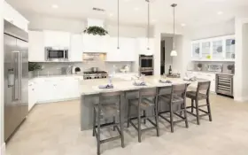  ?? DAVIDON HOMES ?? Kitchens at Andersen Ranch offer slab granite countertop­s, wood cabinetry, spacious dining islands and KitchenAid profession­al series appliance packages.