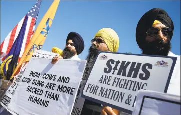  ?? ARIC CRABB — STAFF PHOTOGRAPH­ER ?? Members of the Bay Area Sikh community Harpreet Singh, left, Harjeet Singh, center, and Kamaljeet Singh, right, protest for Sikh rights in India during Sunday’s India Day Parade. About 100Sikhs came out to loudly protest.