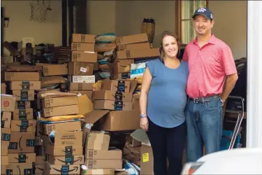  ?? Christian Abraham / Hearst Connecticu­t Media ?? Lisa and Jeff Manheim with thousands of donated books at their home in Stamford on Thursday. Their son Emmet, below, should be celebratin­g his bar mitzvah this weekend, but a blood disease took his life at age 10. Lisa decided that to honor her son, she would undertake a bar mitzvah project by organizing a book drive for Stamford elementary schools.