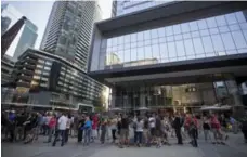  ?? NAKITA KRUCKER/TORONTO STAR FILE PHOTO ?? Fans of the Tragically Hip wait outside the Air Canada Centre for the final tour, which sparked the law on software that buys up concert tickets.