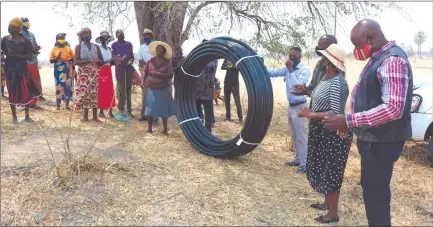  ??  ?? Assistance… Residents of Nzinze village in Kavango West’s Tondoro constituen­cy with one of the bundles of water pipes received from Tulikwates­eni Community Trust.