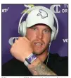  ??  ?? Minnesota Vikings tight end Kyle Rudolph displays a proximity tracking device that players and staff are wearing as part of coronaviru­s protocols. (AP/Dave Campbell)