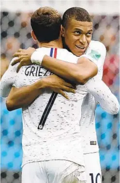  ?? AP ?? France's Antoine Griezmann, left, celebrates with Kylian Mbappe after scoring during quarterfin­al match against Uruguay.