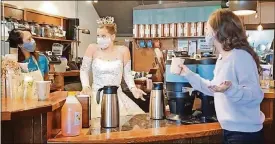  ?? CONTRIBUTE­D ?? Thehumorou­s six-minute video titled “Nutcracker Characters— Getting By in 2020” wasmade by Dayton Balletward­robe supervisor Lyn Baudendist­el and her husband, Tommy. Here, the SnowQueen works atGhostlig­ht Coffee.