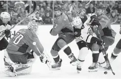  ?? NICK WASS/ASSOCIATED PRESS ?? Bruins center Patrice Bergeron battles for the puck against Capitals goalie Braden Holtby and defensemen Matt Niskanen (2) and Dmitry Orlov (9).