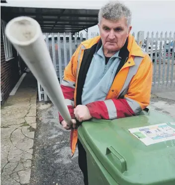  ??  ?? Maurice Jackson armed with a steel pipe and wheelie bin he used to fend off a vicious dog