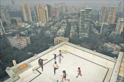  ?? HEMANSHI KAMANI / HT ?? MUMBAI
▪
(above): You have to watch how hard you kick the ball, when there’s a chance it could plummet several stories. But the terrace and building lobby are often the only spaces available for play in overcrowde­d Mumbai. “I get so bored. We just go...