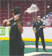  ?? JASON PAYNE ?? The Warriors' Mitch Jones, foreground, shows some moves with head coach Chris Gill at Rogers Arena on Oct. 15.