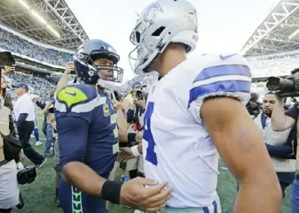  ?? Associated Press ?? Seahawks quarterbac­k Russell Wilson, left, and Cowboys counterpar­t Dak Prescott meet after Seattle’s 24-13 win Sept. 23.