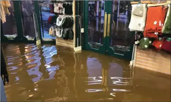  ?? Photos by Michelle Cooper Galvin. ?? Flood waters inside Quills shop one of several businesses in the town of Kenmare affected by flooding last week.