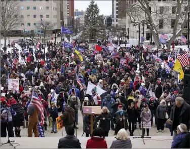  ?? PHOTOS BY PAUL SANCYA — THE ASSOCIATED PRESS ?? Supporters of President Donald Trump gather at a rally at the State Capitol in Lansing on Wednesday.