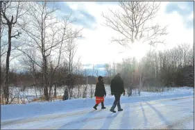  ??  ?? Martineau and Goward walk down the road between Camp Migizi and one of the Enbridge Line 3 work sites.