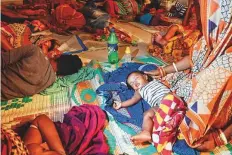  ?? AFP ?? People evacuated for safety rest in a temporary cyclone relief shelter in Puri, Odisha, yesterday.