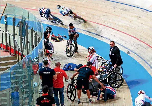  ?? GETTY IMAGES ?? Riders are sprawled trackside after being embroiled in a spectacula­r crash during the women’s scratch race in Poland.